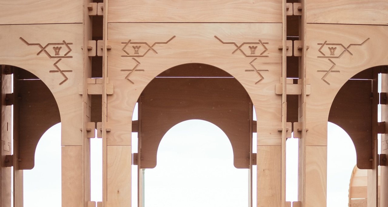 A close-up of the wall panelling used to create the Riwaq. Arabic-inspired etchings can be seen at the top of the Riwaq's archways.